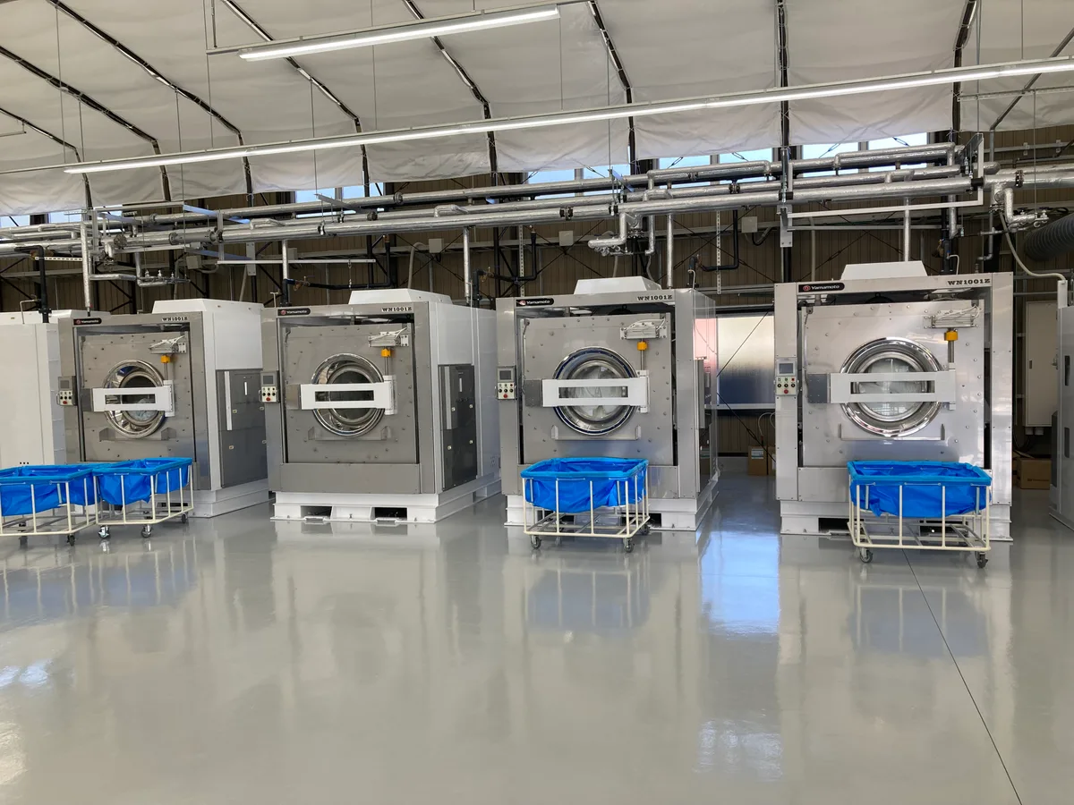 Yamamoto industrial washer-extractors with laundry carts in an on-premise laundry